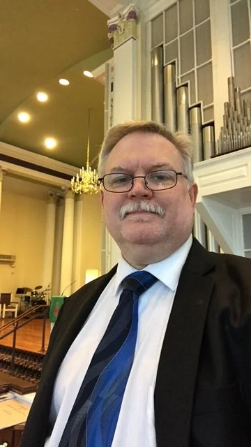 Generic user profile icon with a white silhouette on a red and black background.