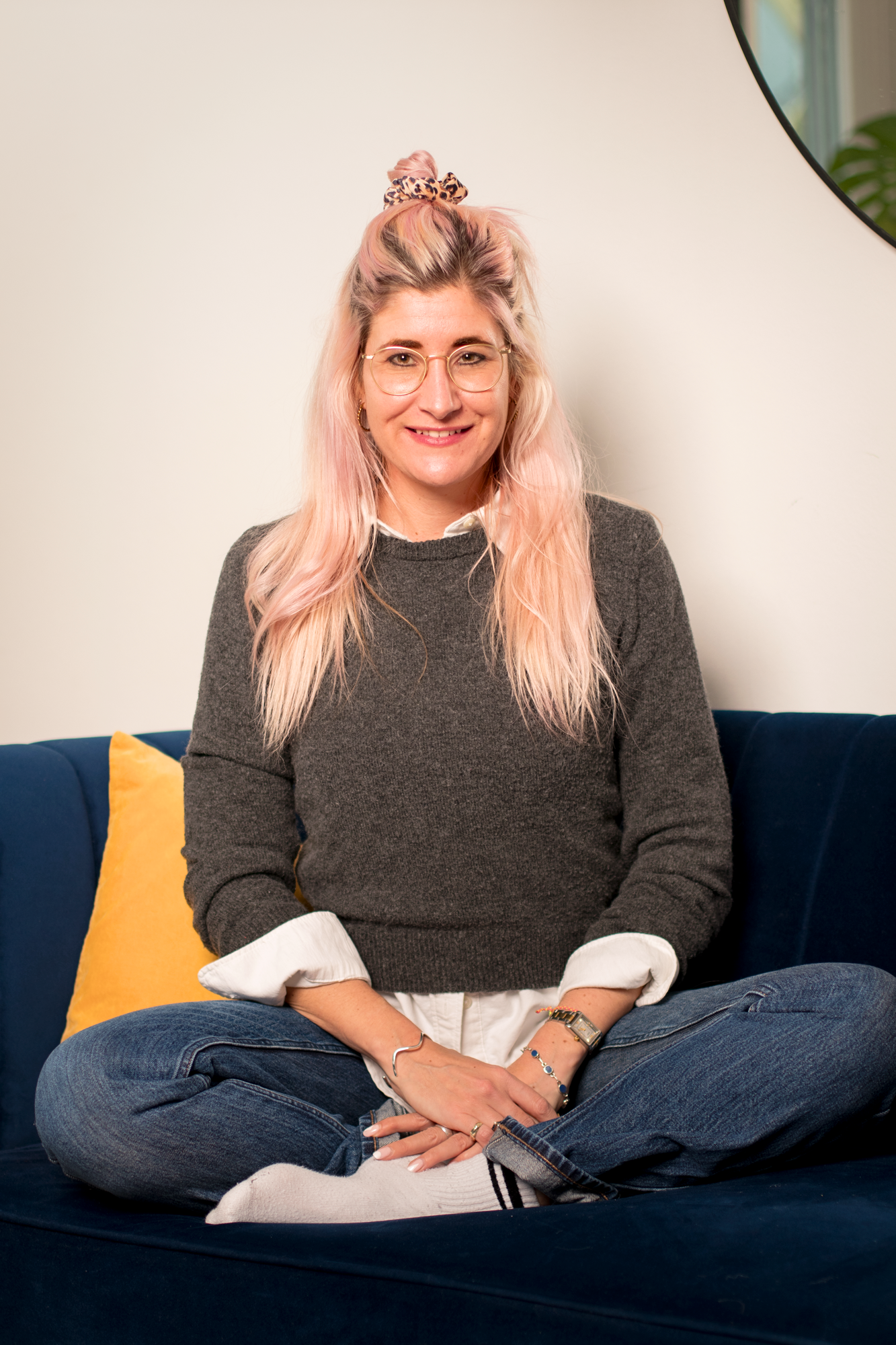 A picture of Zoe Coetzee, expressive arts facilitator at the sozo space, sitting on a couch