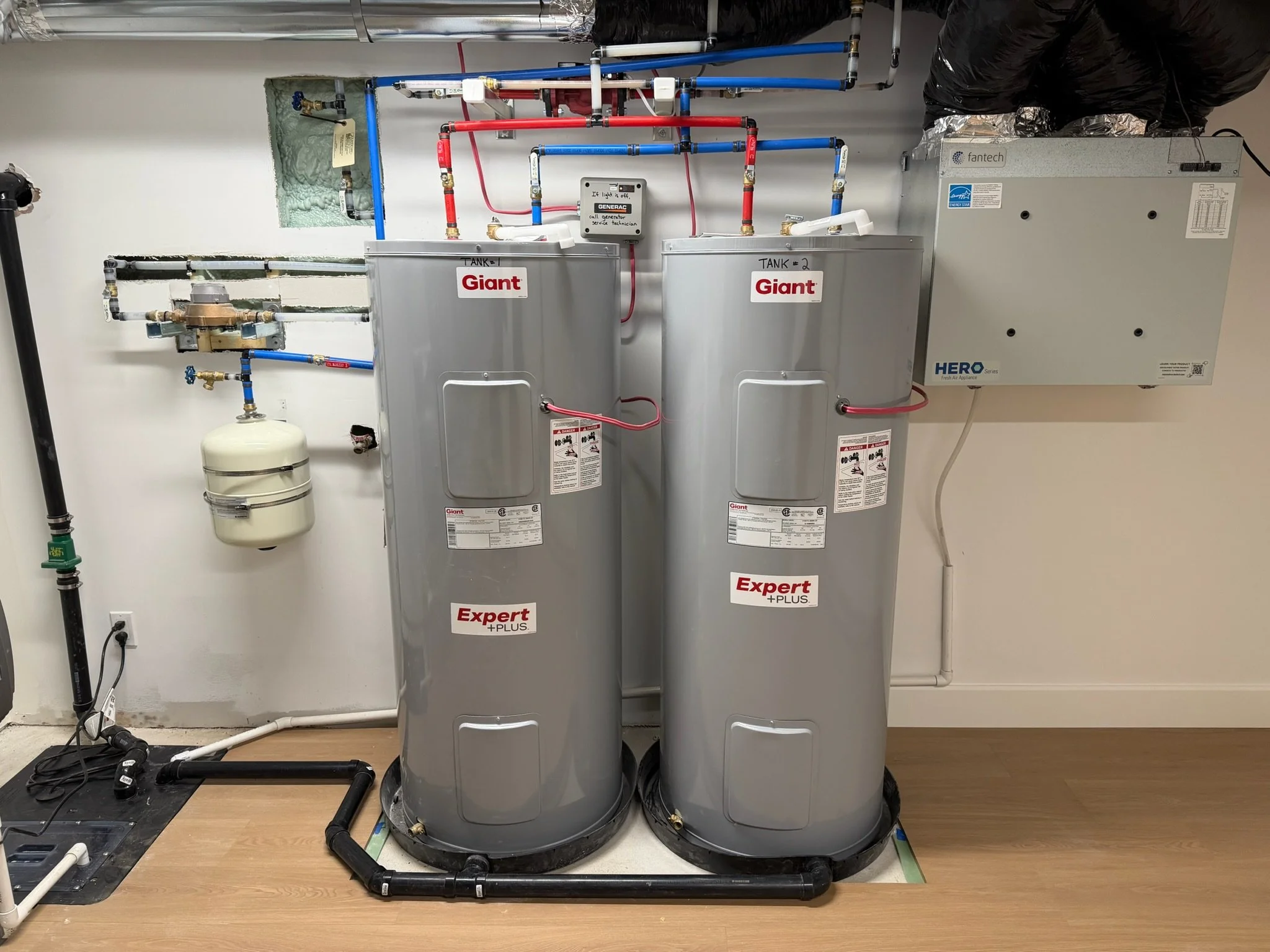 Two large gray water tanks installations.