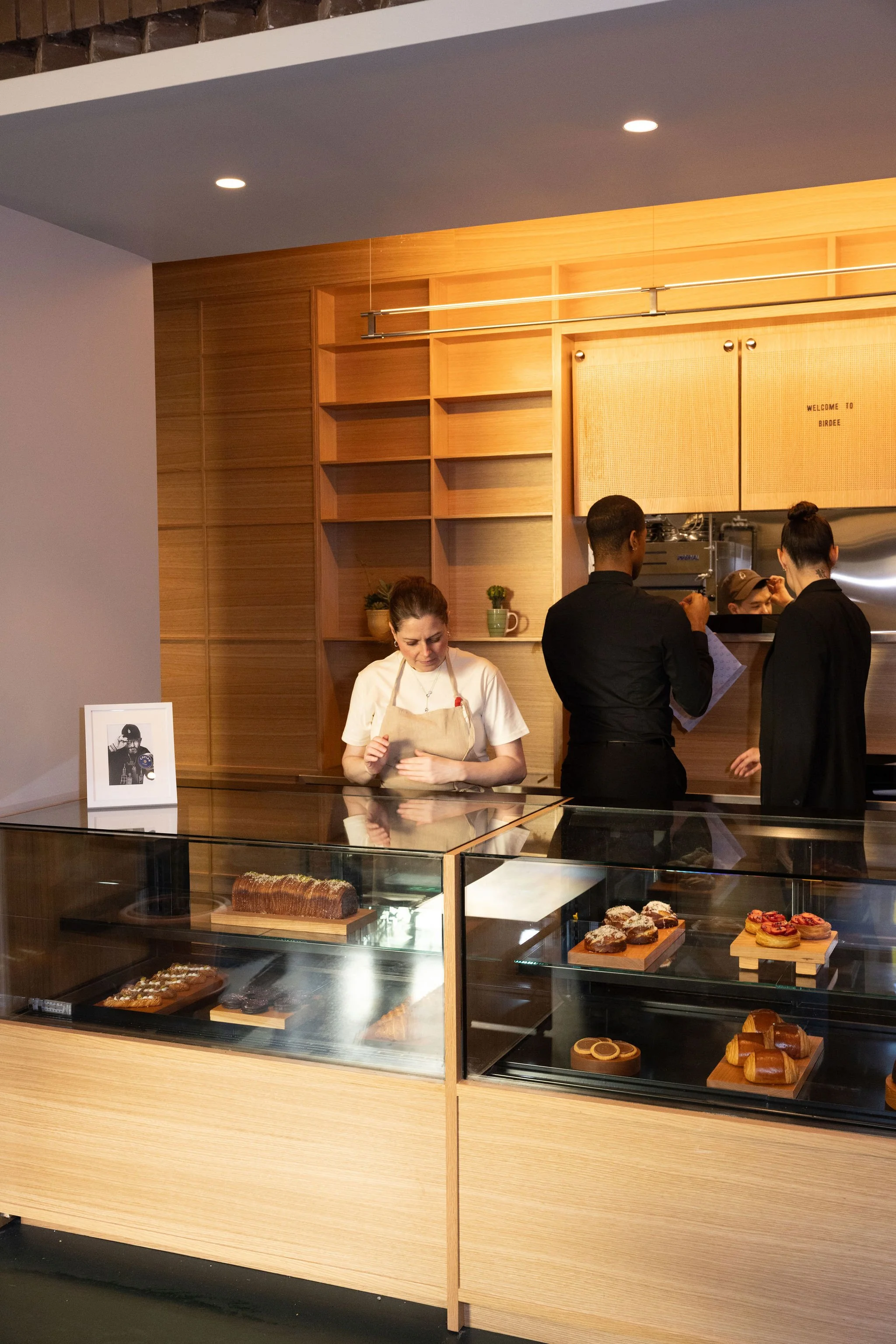 Renata Ameni standing behind the pastry case at Birdee