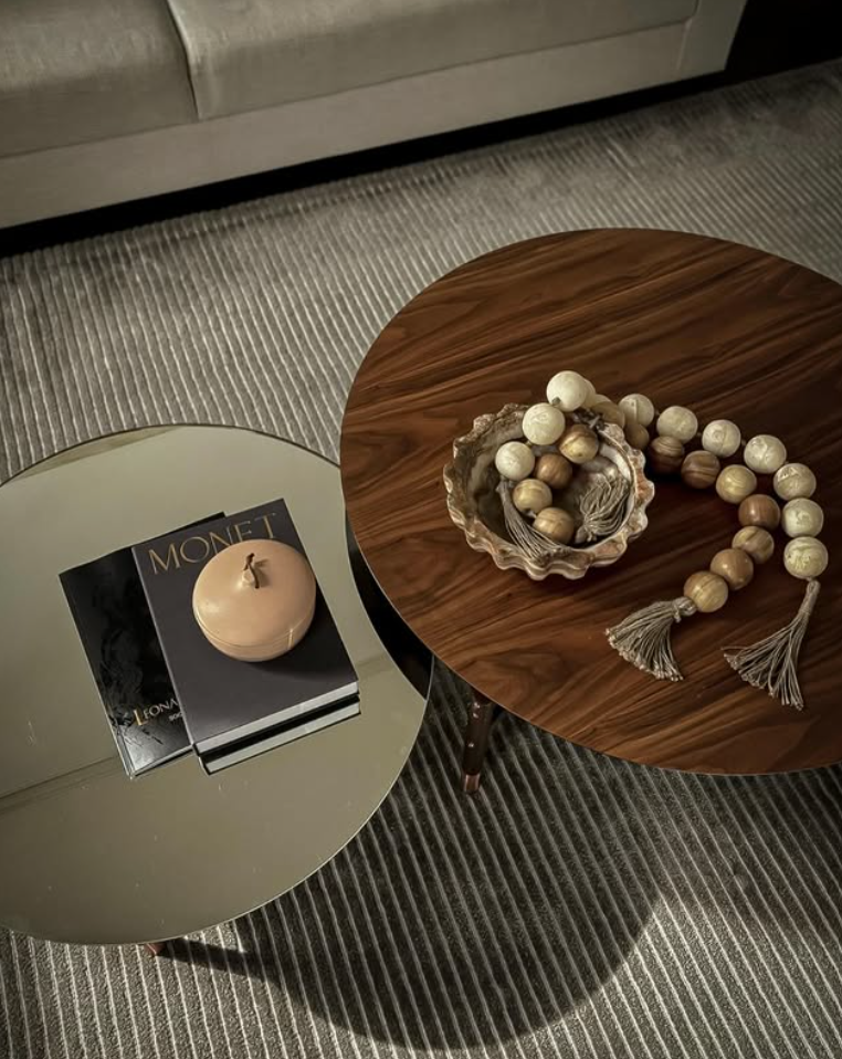 Nesting tables on striped carpet — a curated styling moment by Studio Black Oak featuring layered textures and thoughtful object placement