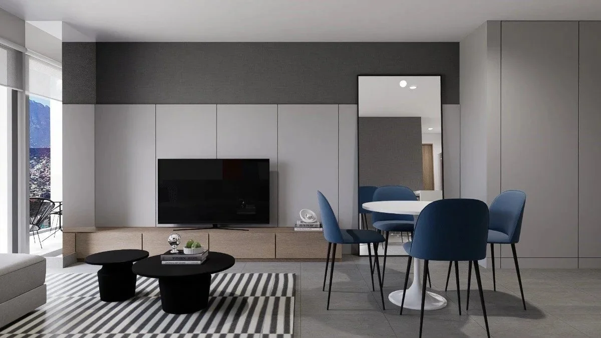 Sala de estar moderna con sillones azules, mesa redonda blanca, televisión, espejo y muebles en tonos neutros.