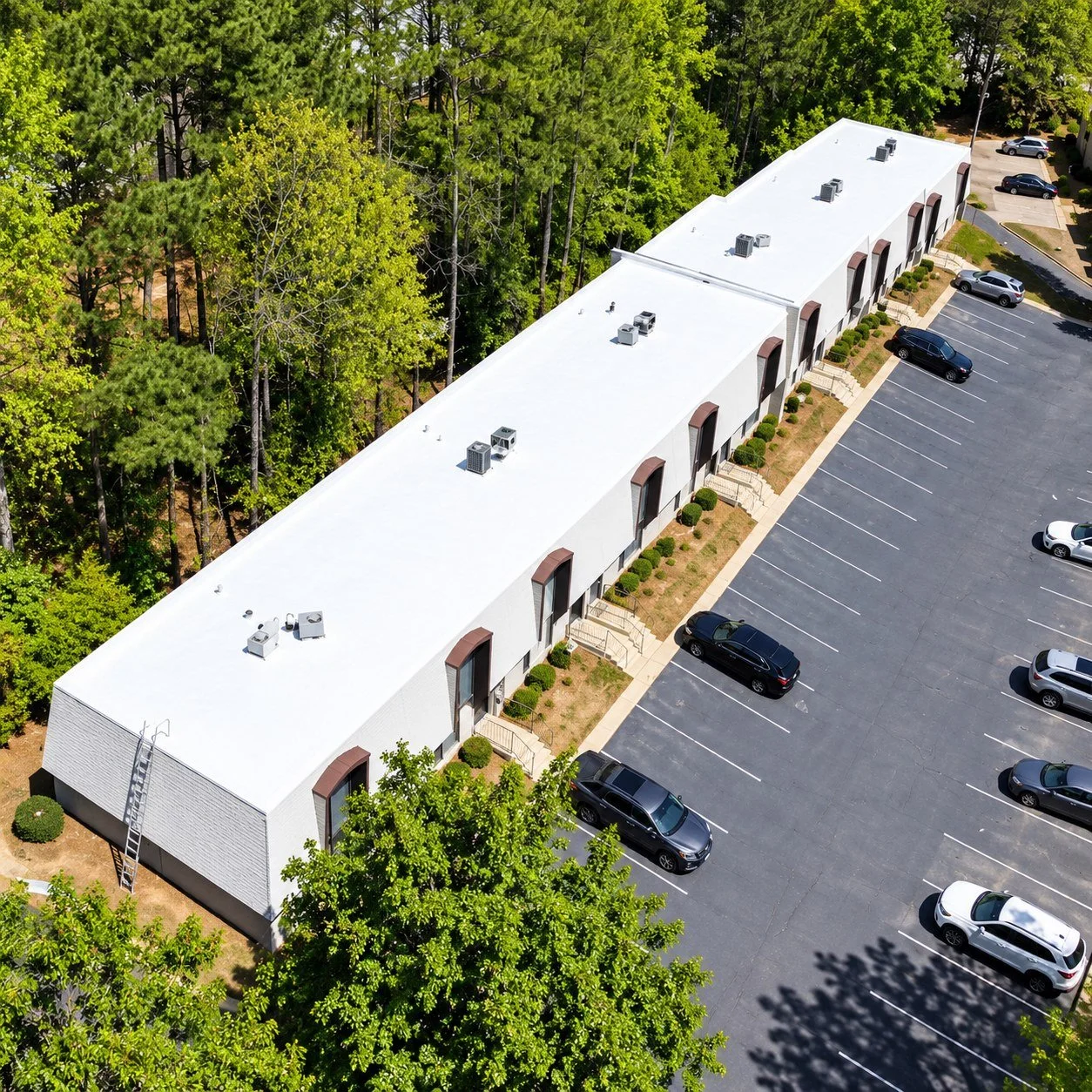 Commercial building with white silicone roof coating, aerial view - GreenLight Roofing Florida