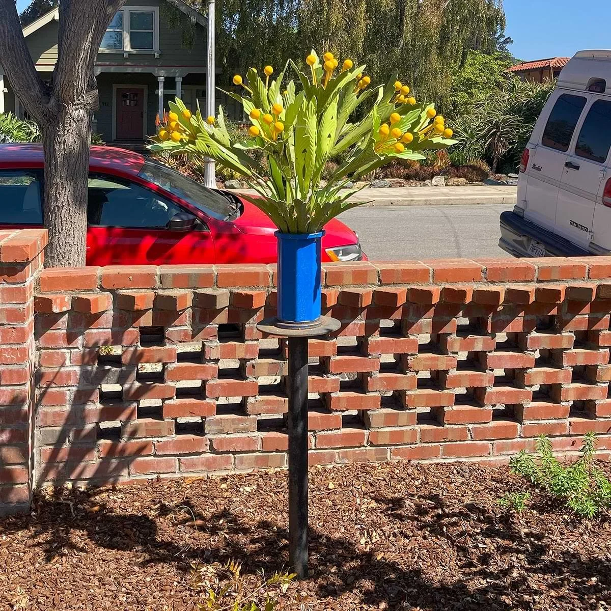 Flowers in a blue vase garden sculpture by Dwight Hammack,