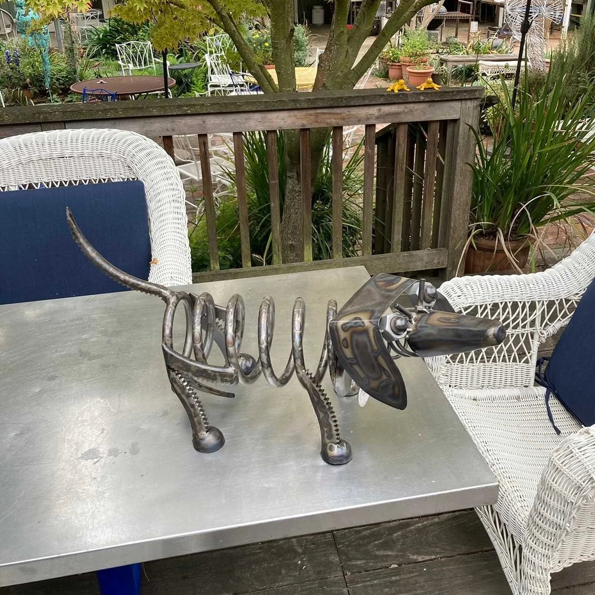 Metal dog sculpture by Dwight Hammack.