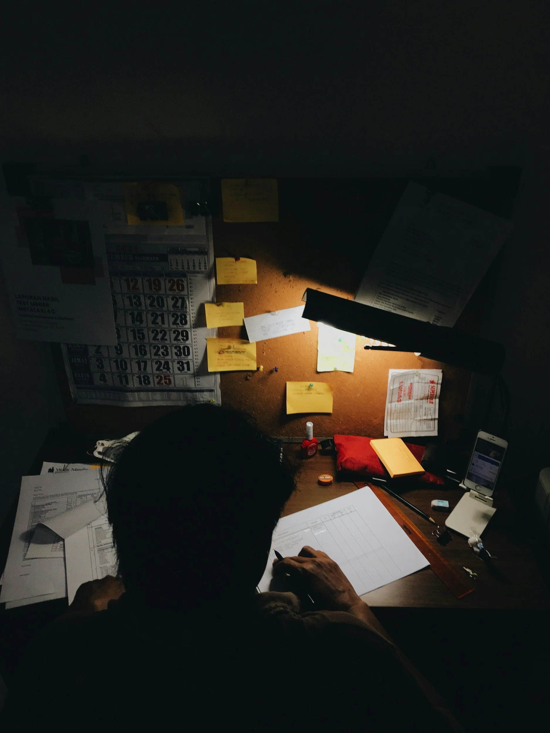 Messy desk with notes, lists, calendars representing executive functioning struggles from ADHD