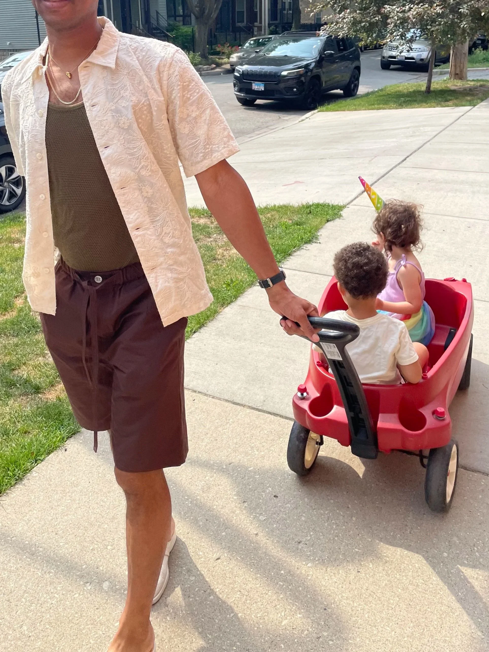 A dad pulls his kids in a wagon in Chicago displaying the journey of parenthood and how therapy can help