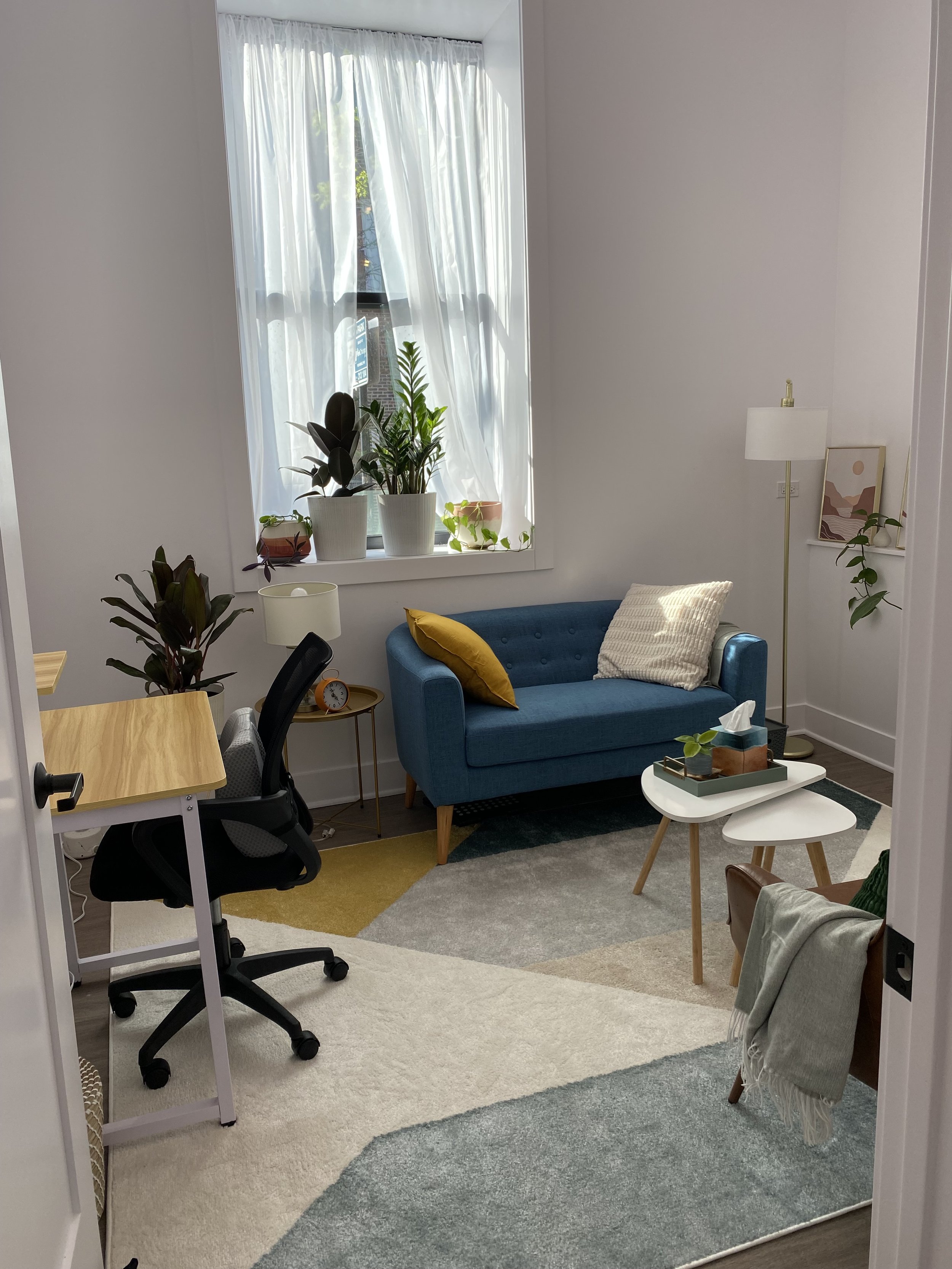 A bright, sunny office for therapy in Logan Square with a male and female therapist open to in-person and virtual sessions.