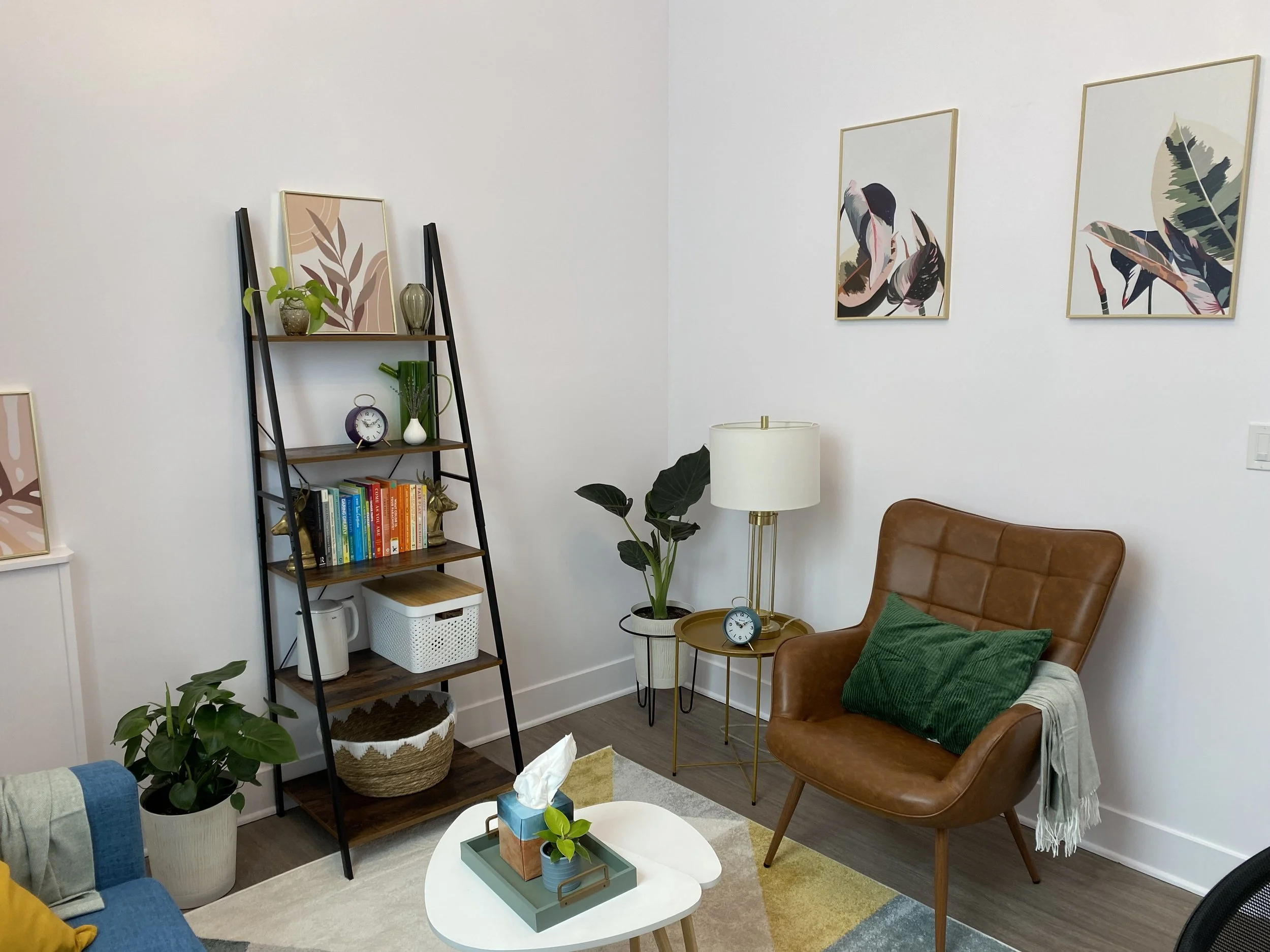 Cozy Logan Square office for in-person therapy featuring books on anxiety, highly sensitive persons, and parenting.