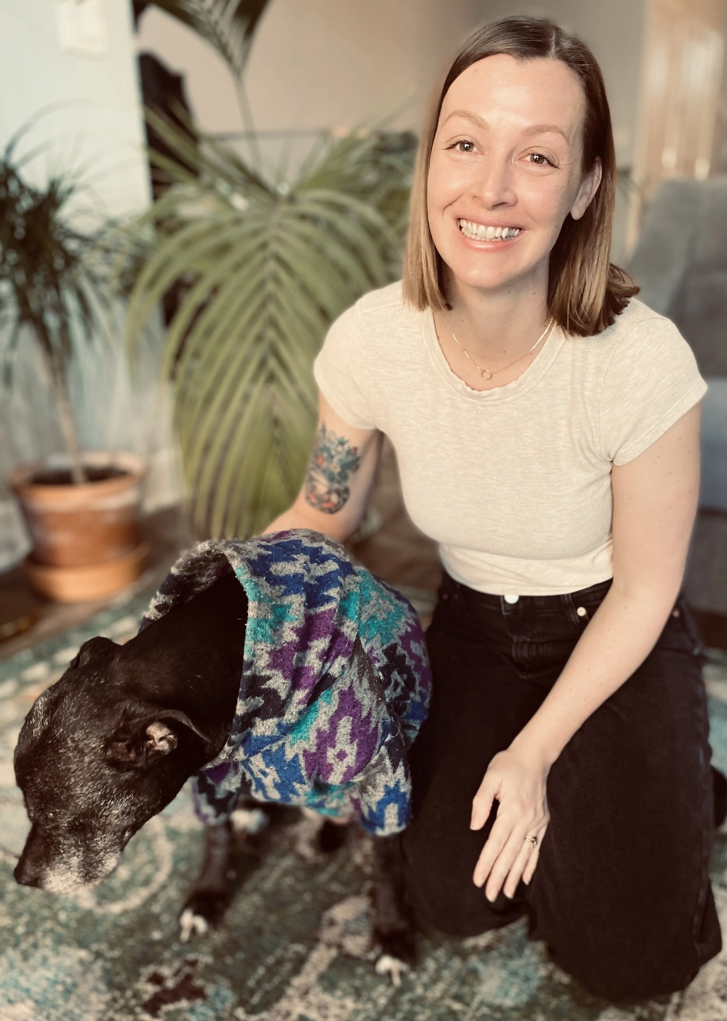 Smiling therapist who loves dogs and plants.