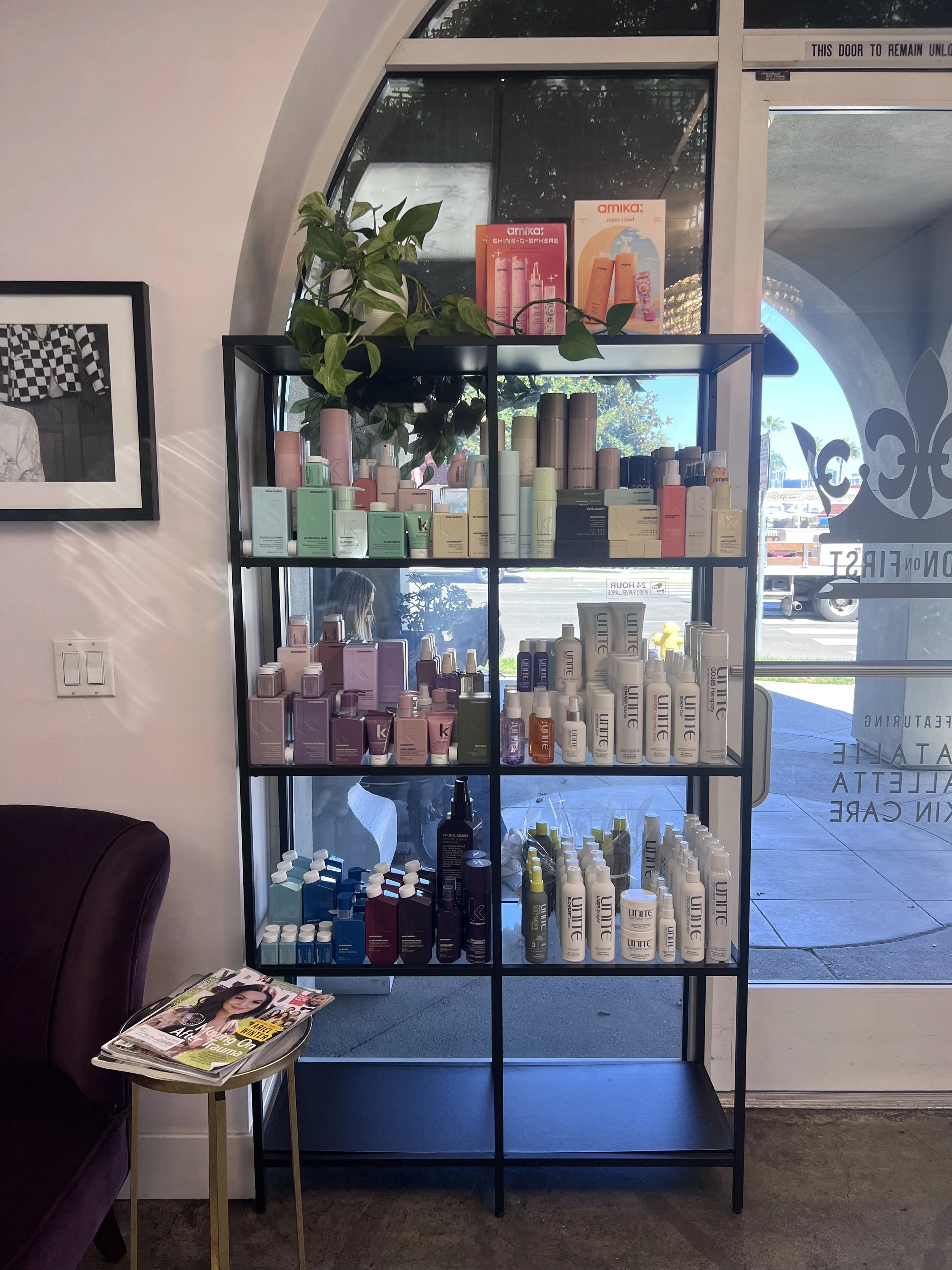 AFTER at the Salon's product display shelf! 
Post re-merch - clear space adds light and lightness to a display, plus, it's much less likely that anyone will buy something off the bottom shelf. Tighten it up! 
A hearty plant like pothos, which thrives