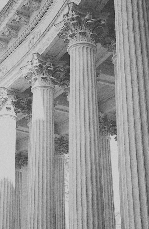 Close-up of a classical marble Corinthian column showing ornate capital and fluted shaft.