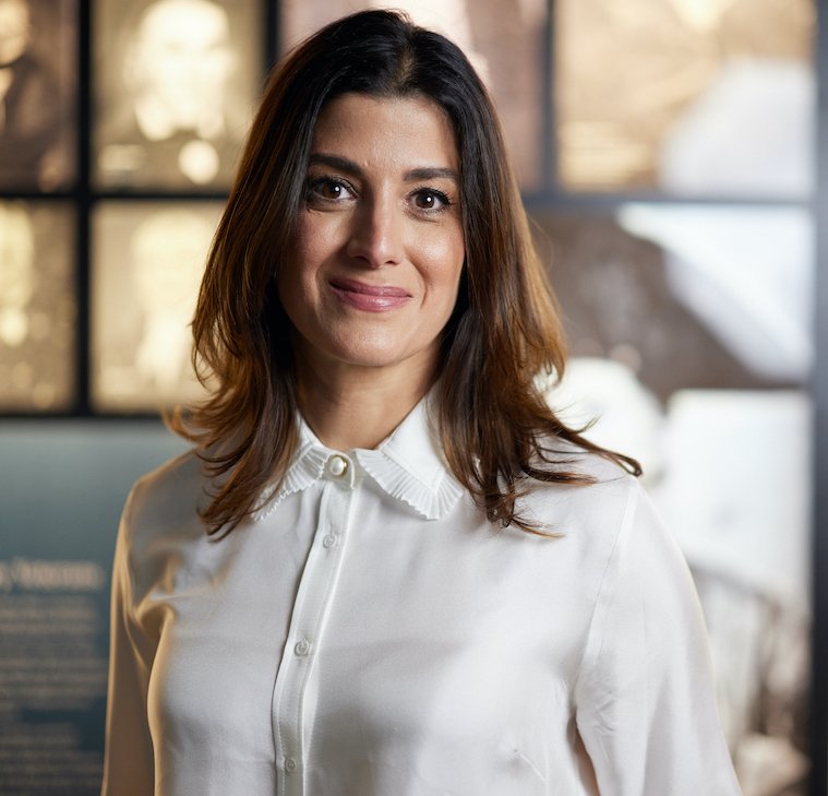 Ambassador Nathalie Rayes smiling wearing a white blouse