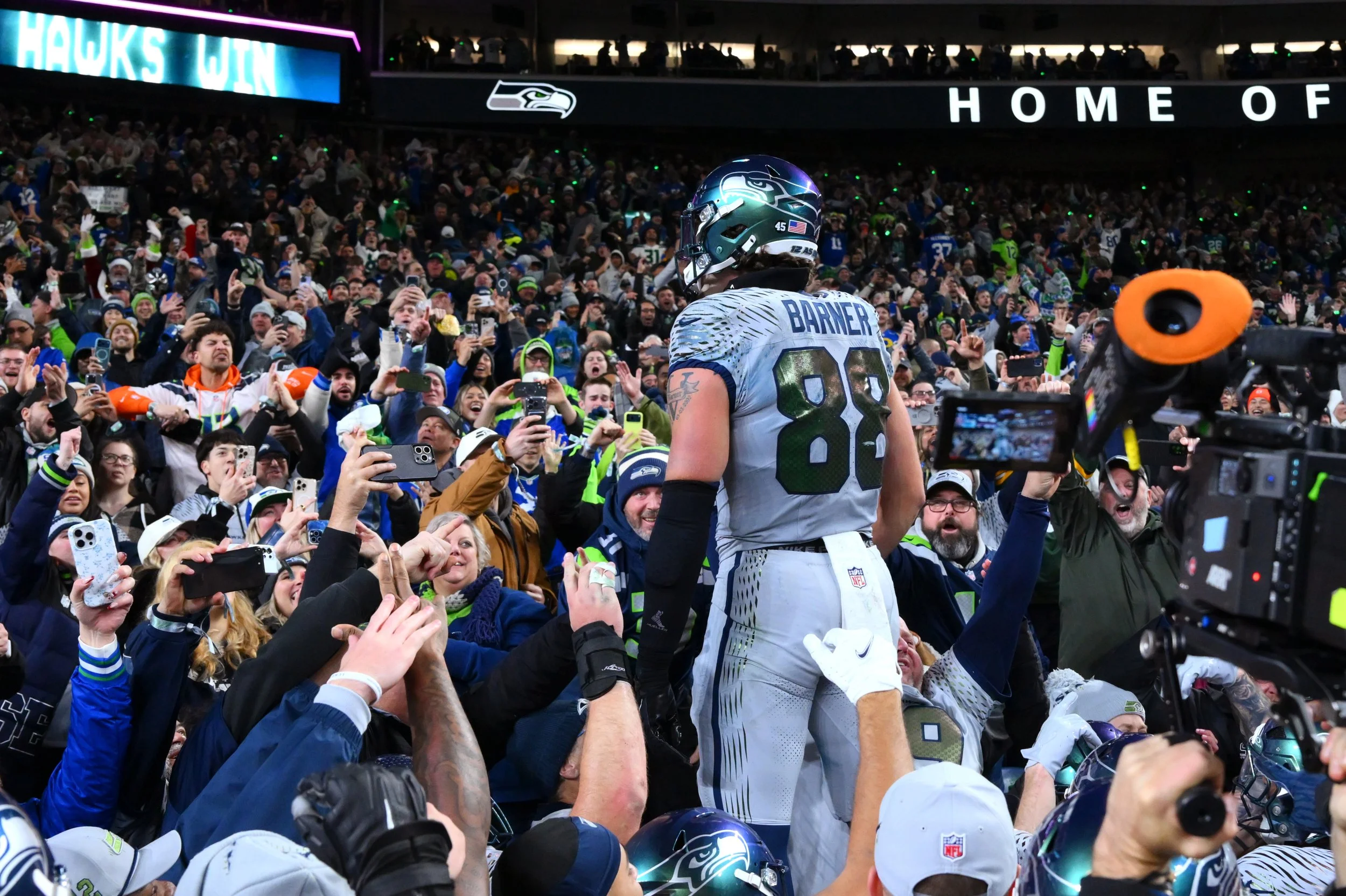 Seattle Seahawks tight end AJ Barner (88) celebrates with fans after a win against the Los Angeles Rams in overtime at Lumen Field. Mandatory Credit: Steven Bisig-Imagn Images