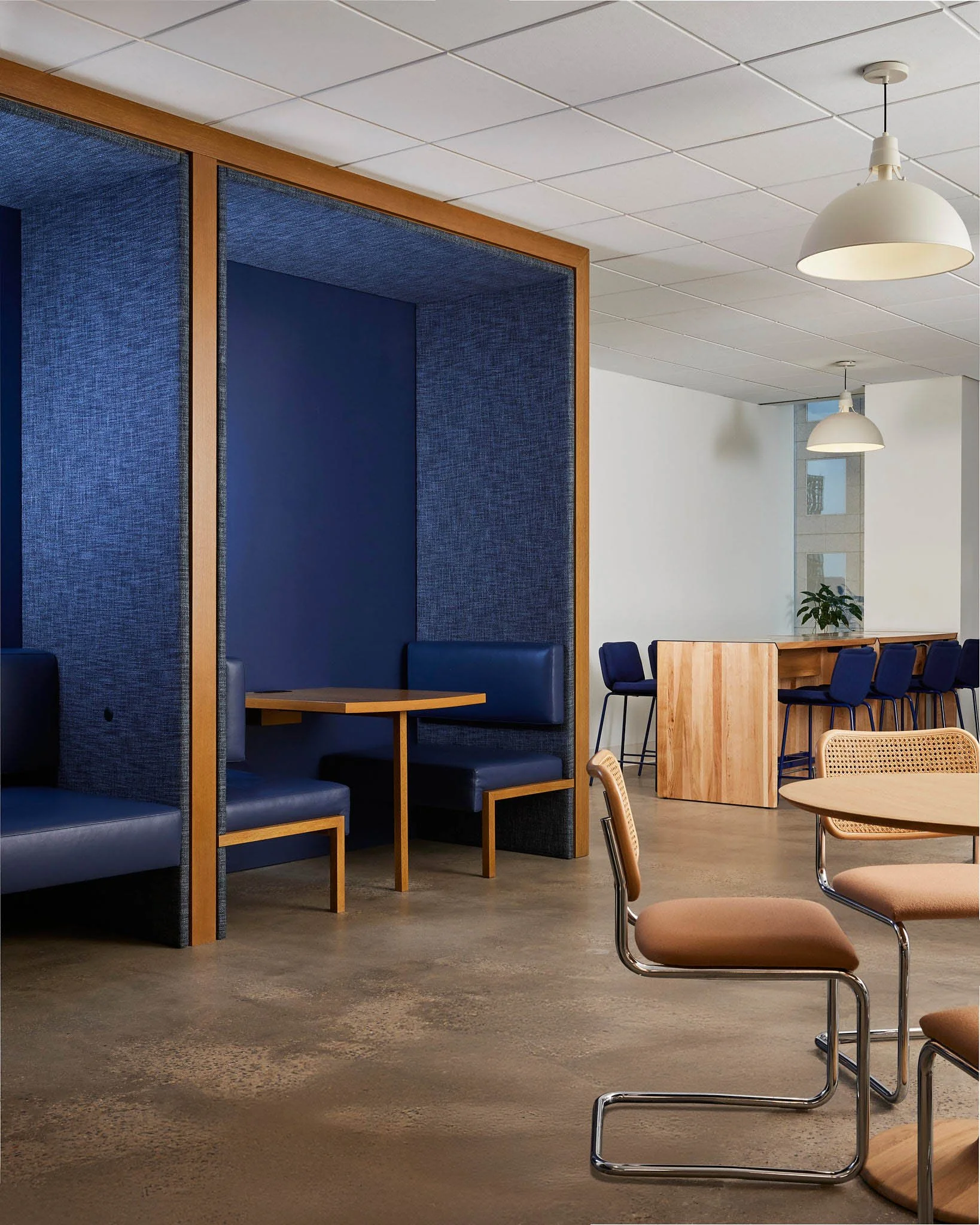 Commercial Rug Showroom photography with bold, yellow abstract wall art, black mirrors, modern furniture, and contemporary decor accents.