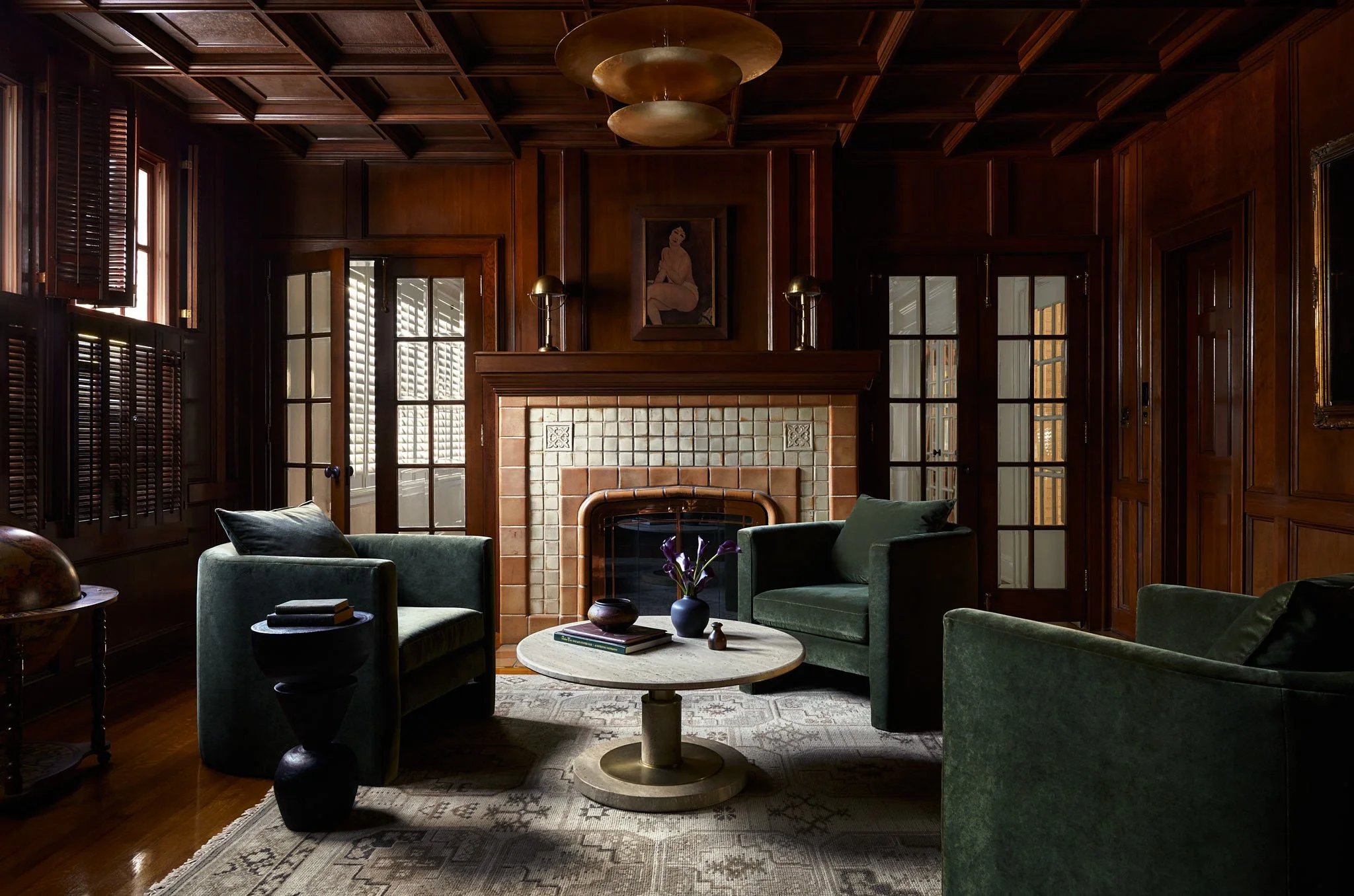 Luxury Interior Photography of a moody fireplace lounge at a historic spanish colonial style home in Tampa, Florida. 