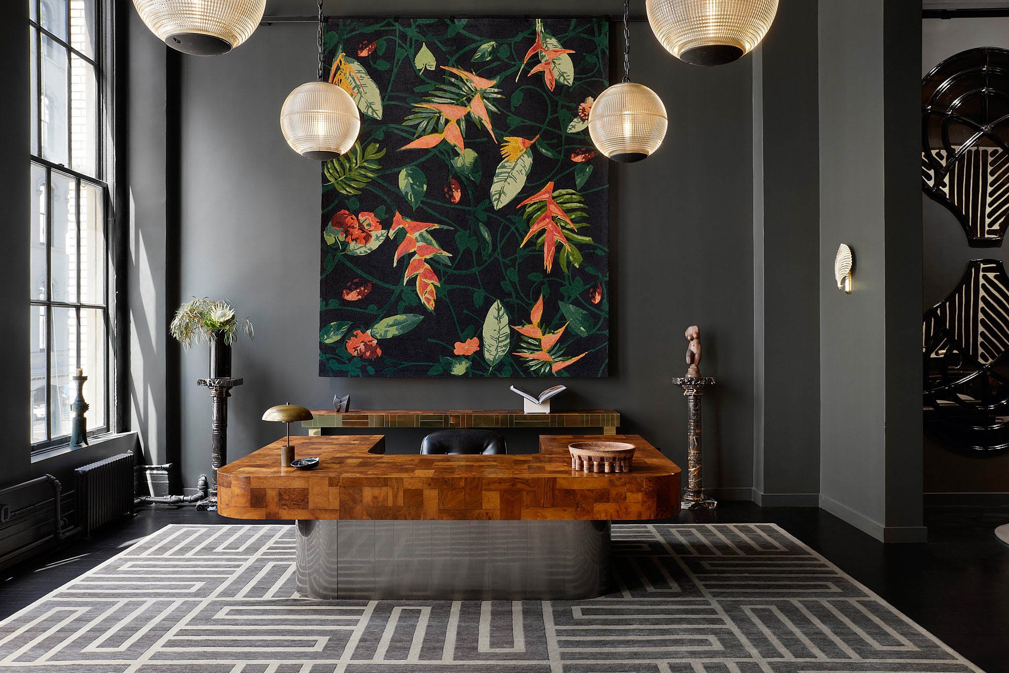 Commercial Rug Showroom photography with bold, yellow abstract wall art, black mirrors, modern furniture, and contemporary decor accents.