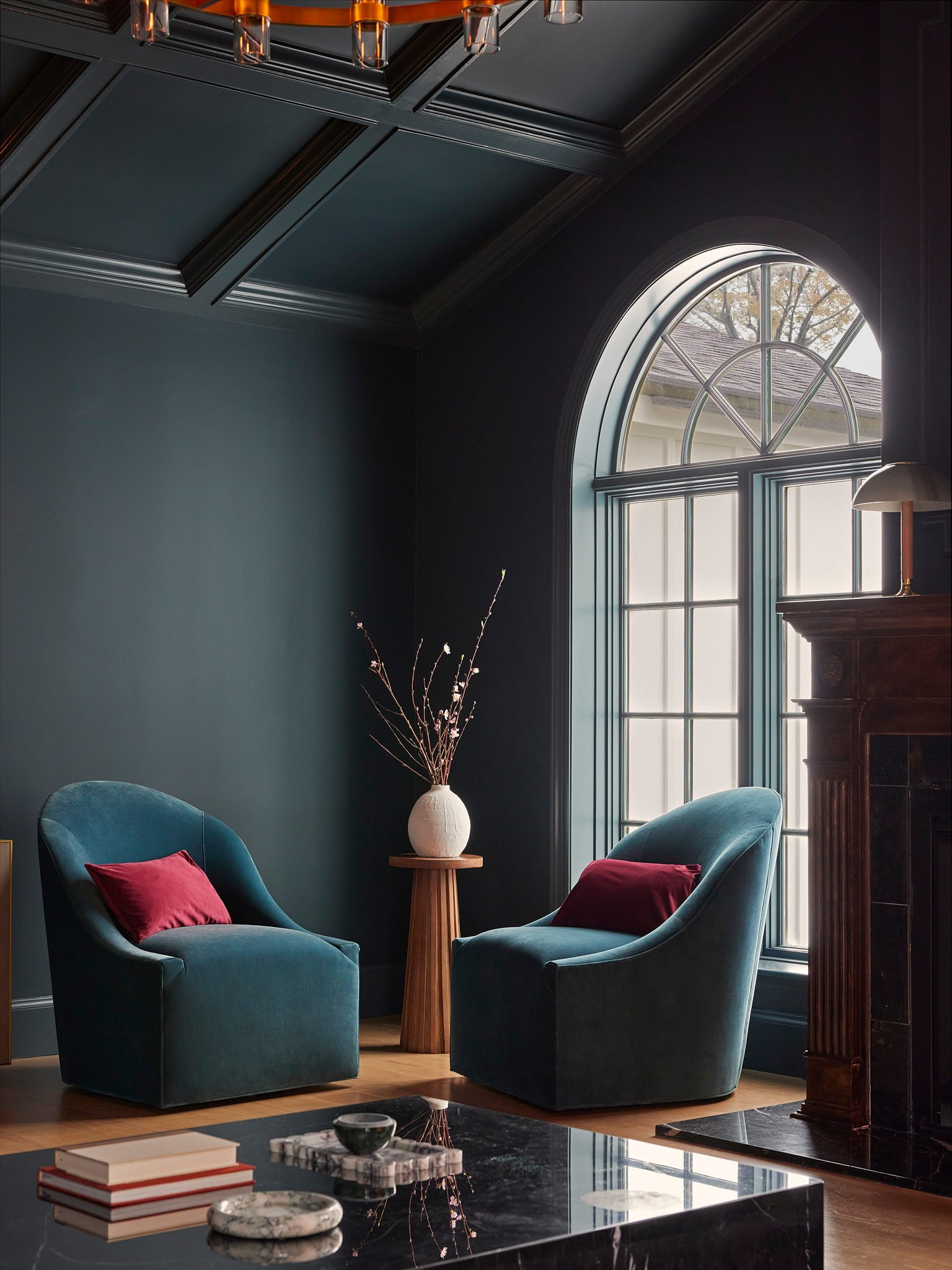 Interior Design Living Room Corner with Branches, Couch Chairs, and a Fireplace Mantel