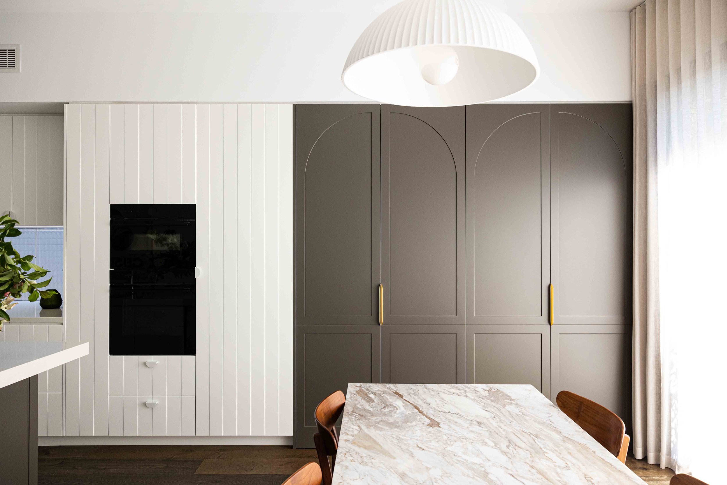 v groove ivory and charcoal kitchen joinery design with half moon handles and contrast door panel designs by kastell kitchens NSW sydney joinery and interior design
