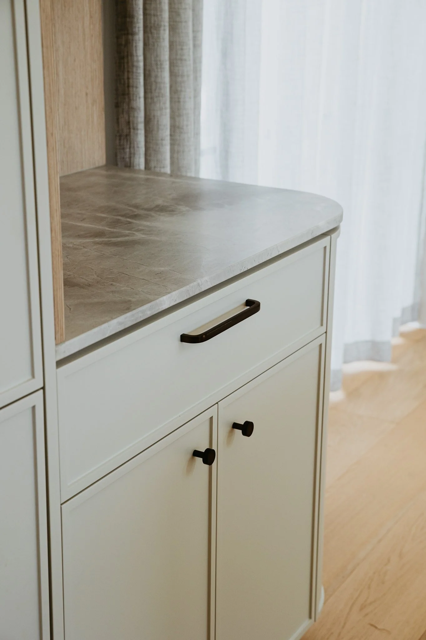 Minimalist kitchen with custom joinery, stone surfaces, and warm timber accents, offering a timeless and functional space for everyday use.