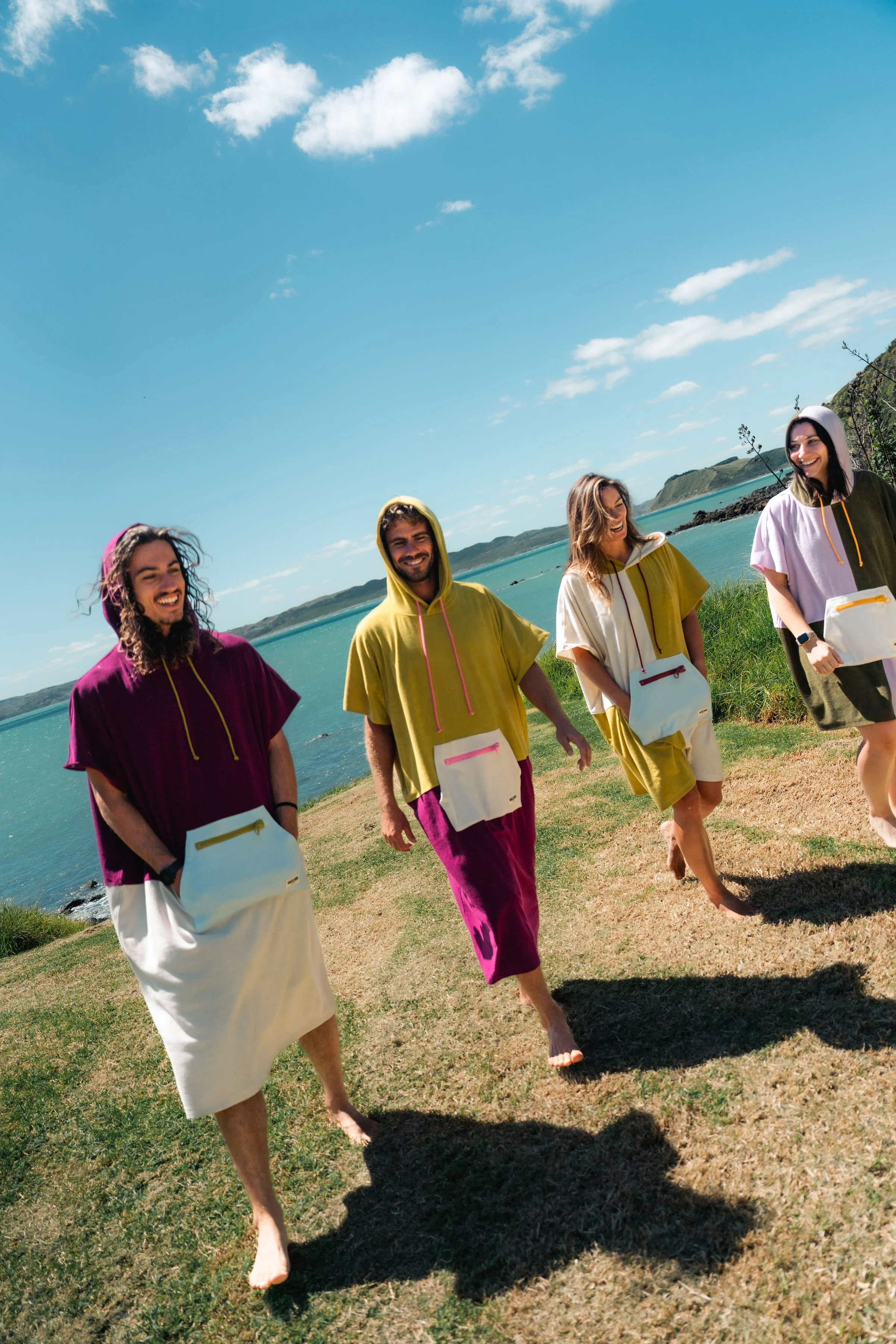 Four friends wearing WaveyDrip towel ponchos
