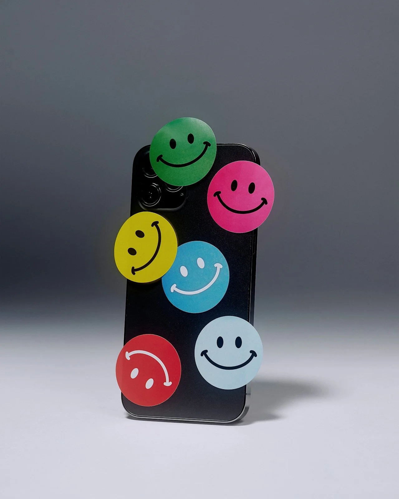 Smartphone with colorful smiley face stickers