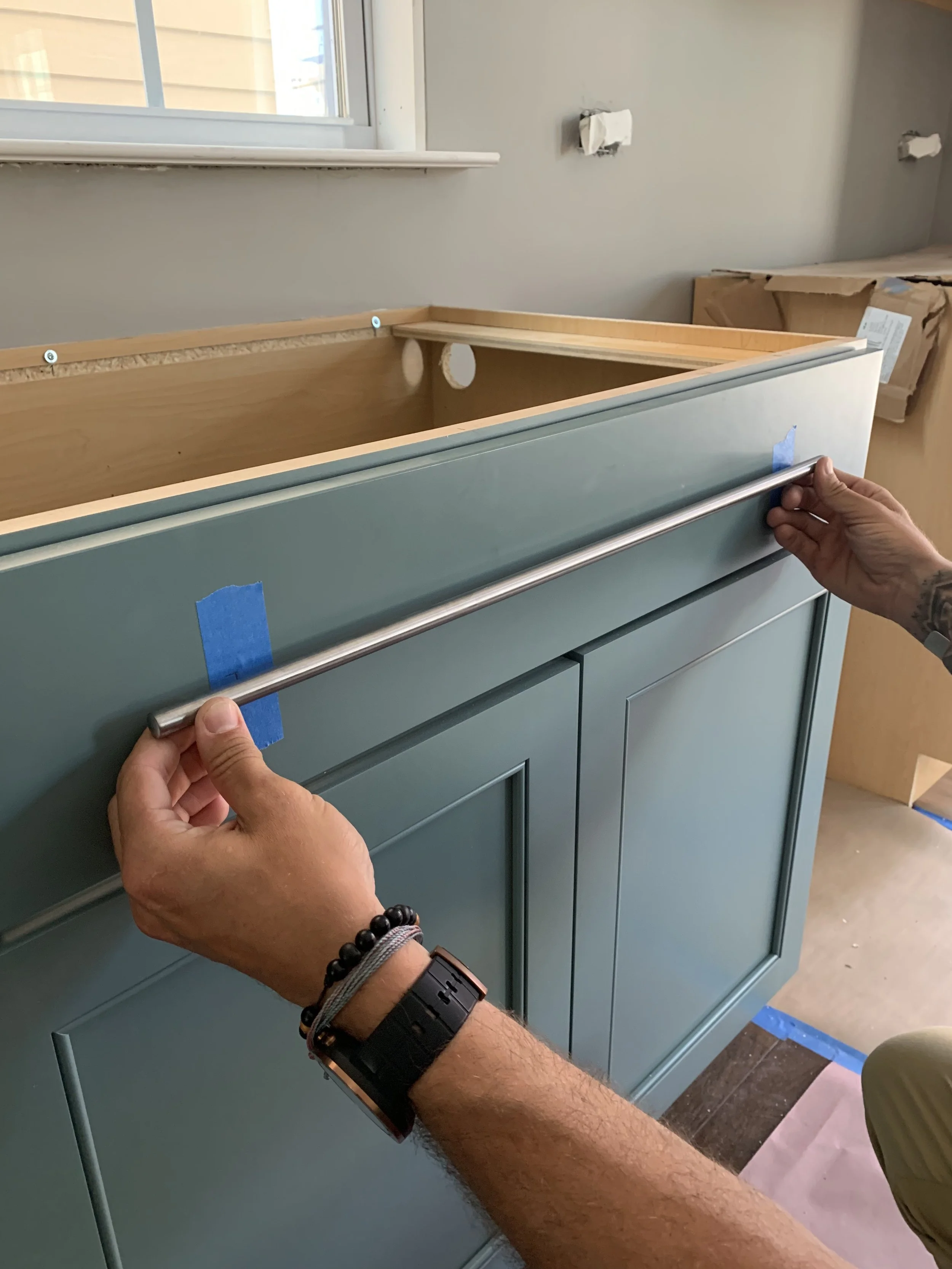 Surefire Construction Group installing a custom cabinet drawer pull in Harrisburg NC