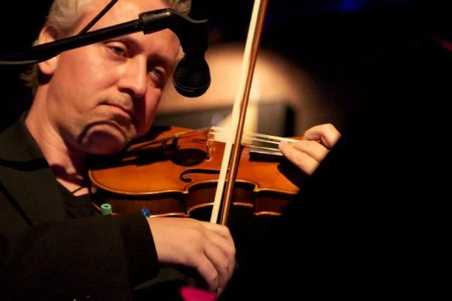 Composer Ludek Drizhal playing violin.