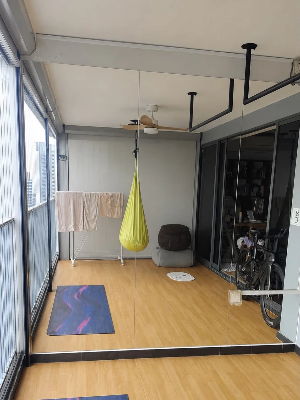 Full-height mirror installation for a home workout area, creating a brighter and more spacious training space.