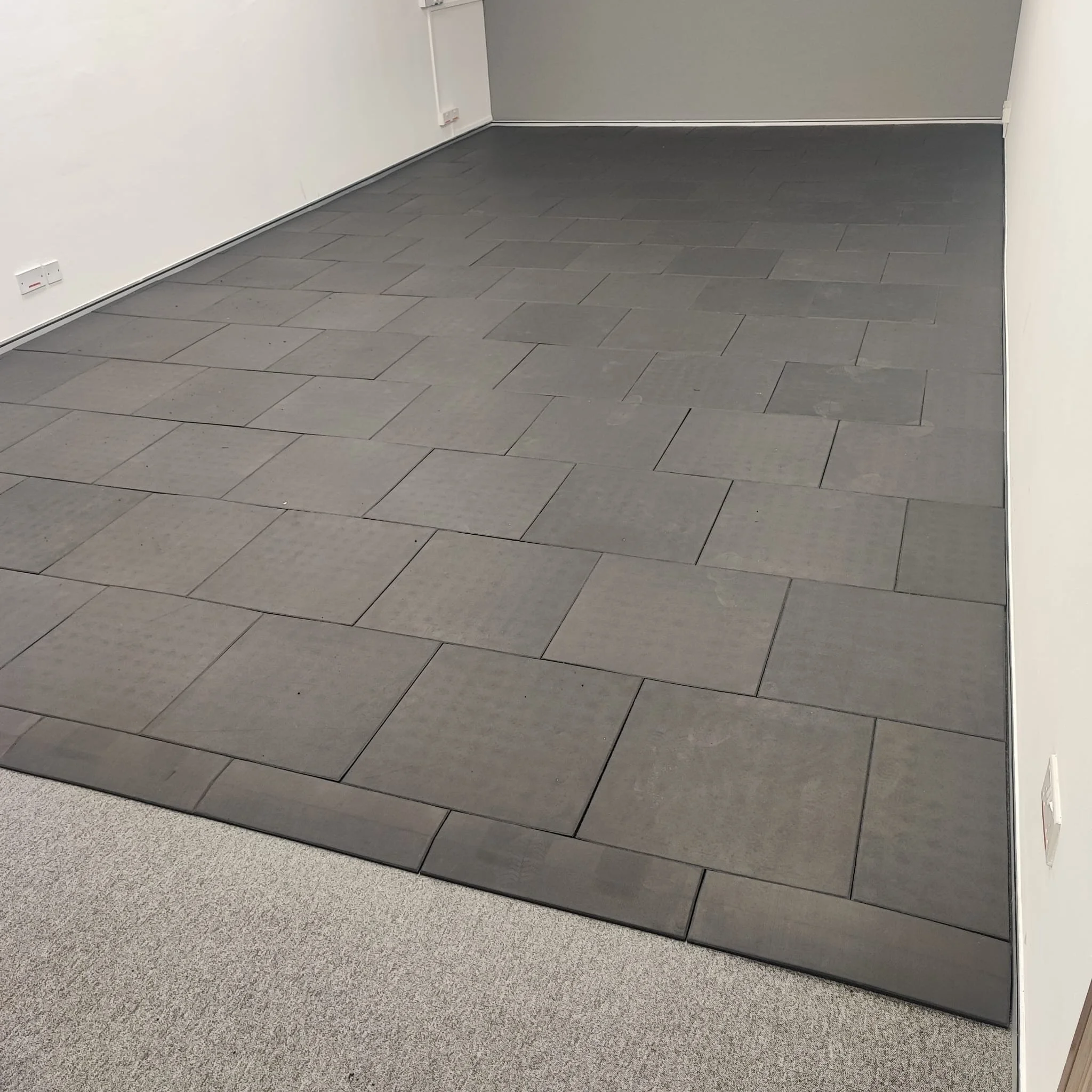 Dedicating a space within the corporate office for gym use. Our rubber flooring was installed in a brick layout, with staggered joints for better stability and a cleaner finish across a larger commercial space.

This layout also avoids continuous joi