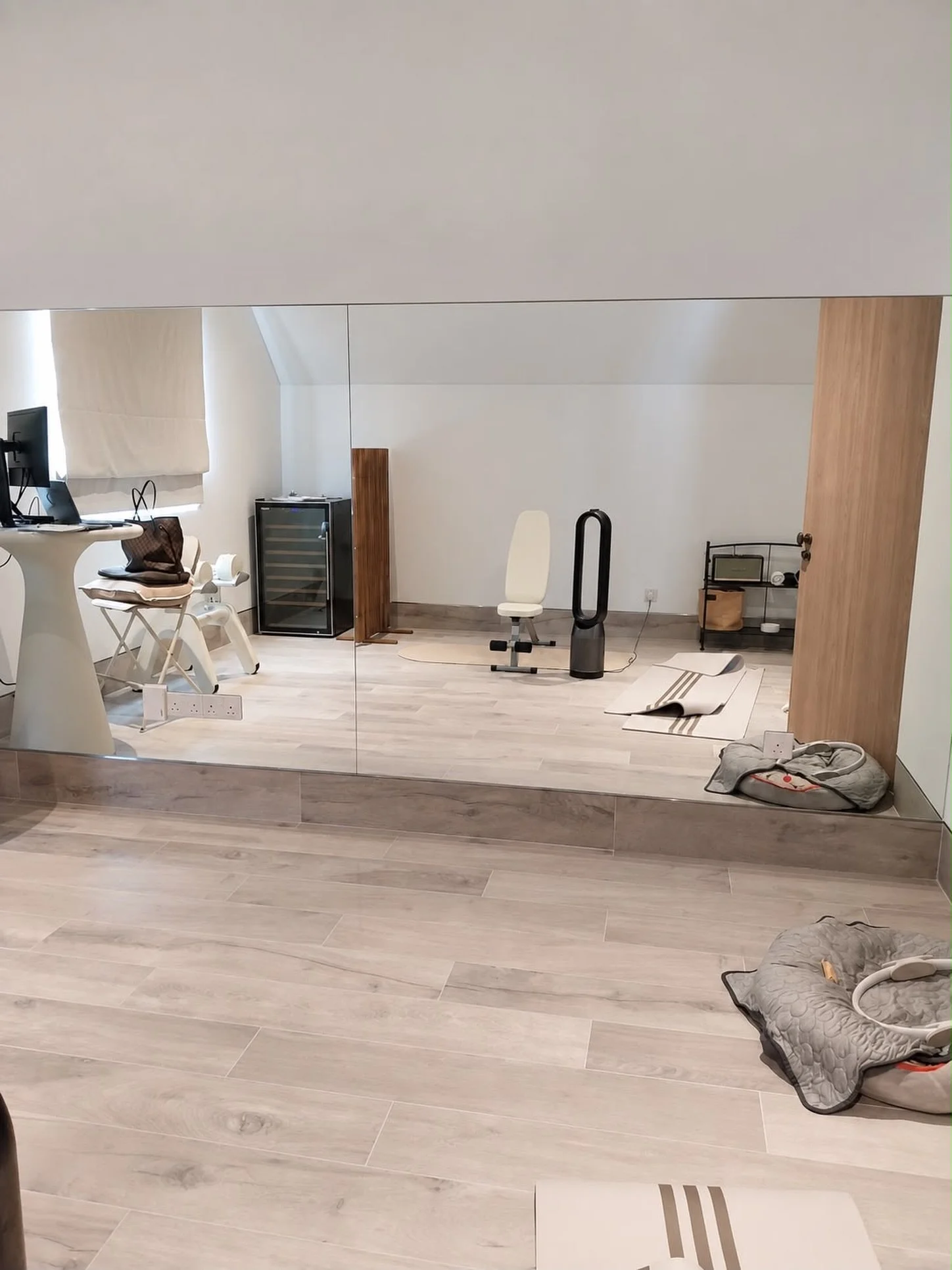 Making the most of every corner of the home.

This attic space was transformed into a functional home office and workout area, fitted with our custom full-length gym mirrors to open up the room, reflect more natural light, and create a brighter, more