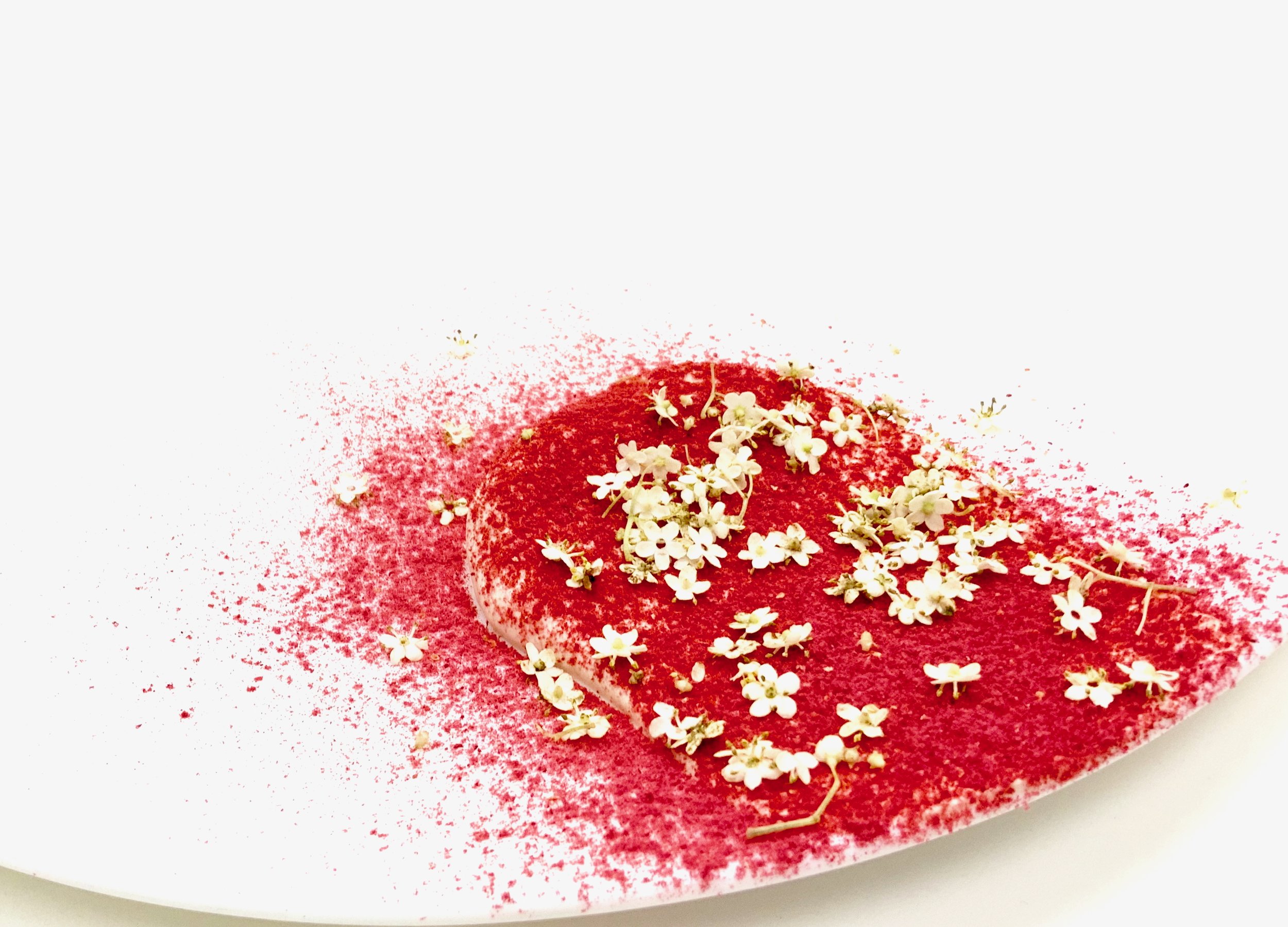 White miso cream dessert with freeze-dried raspberries and elderflower — a floral umami merging fermentation, acidity and elegance.