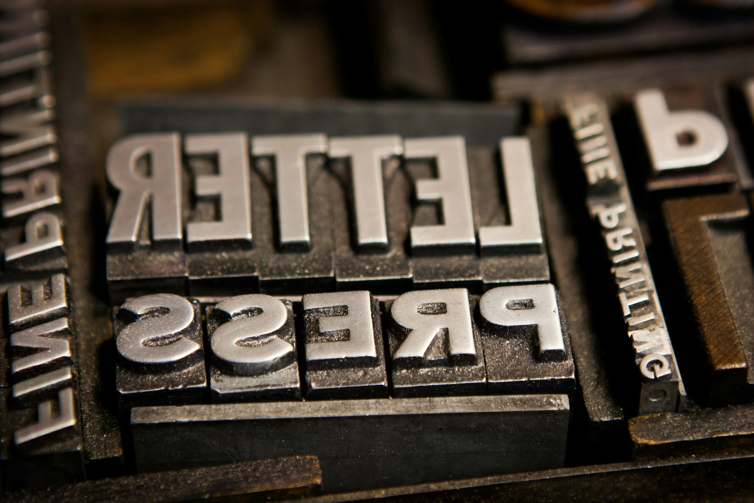 Close-up of vintage metal letterpress blocks with the word 'FREE' typed in capital letters.
