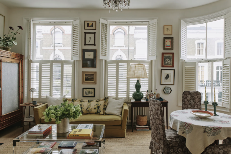 eclectic living room featuring mustard velvet sofa and green lamp in chelsea london