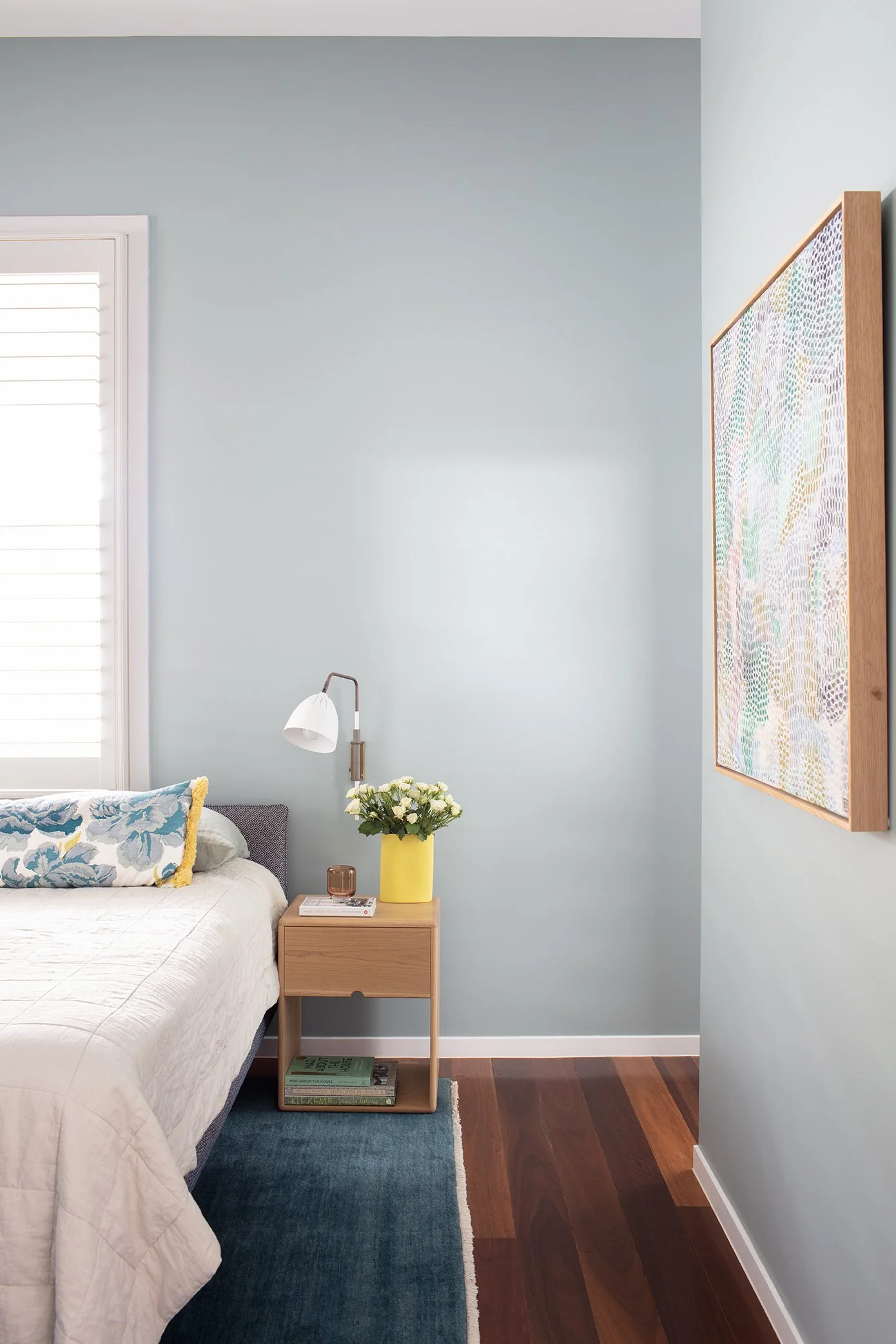 Master bedroom with blue-green walls, custom furnishings featuring peony textiles by Christopher Farr Cloth, and artwork by Brisbane artist Sarah Daly