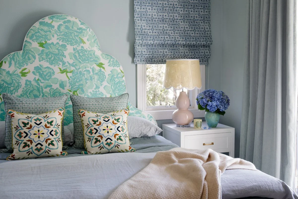 Peony fabric bedhead in pretty blue walls with matching curtains in blue linen in this main bedroom
