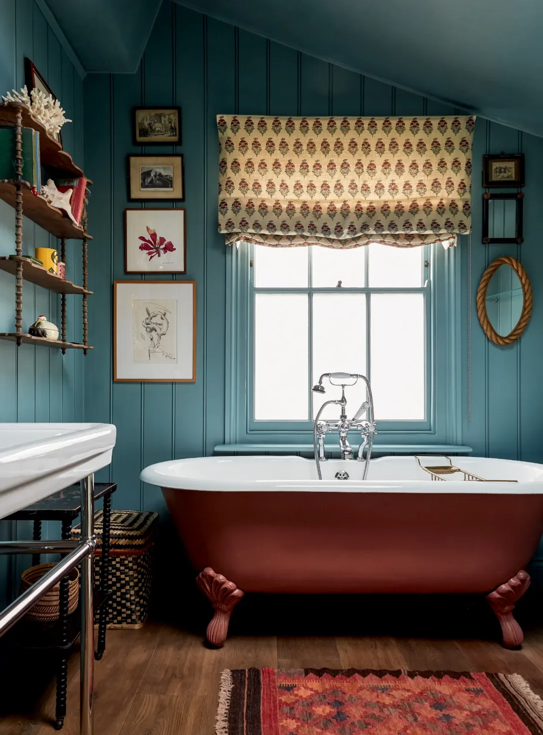 Blue painted walls and red bath in Bathroom by Lonika Chand