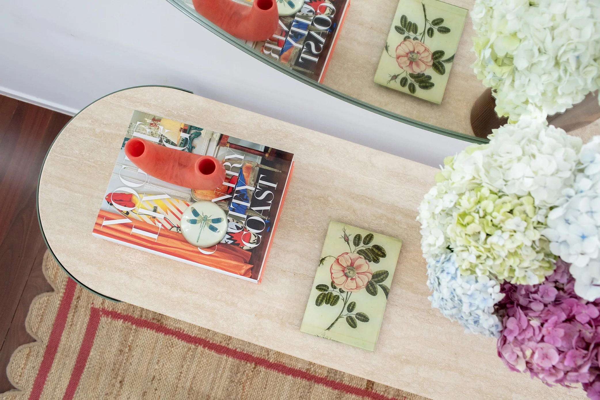 Colourful entry table styled with vibrant decor, fresh flowers, and curated accessories creating a welcoming Queenslander cottage entrance