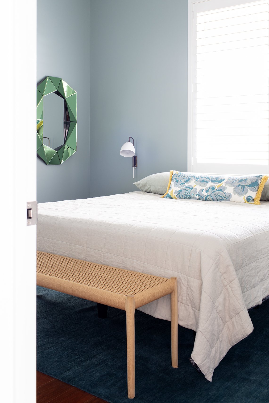 Master bedroom makeover in a Queenslander cottage, introducing blues, greens, and pops of yellow in walls, furnishings, and rugs replacing all-white decor