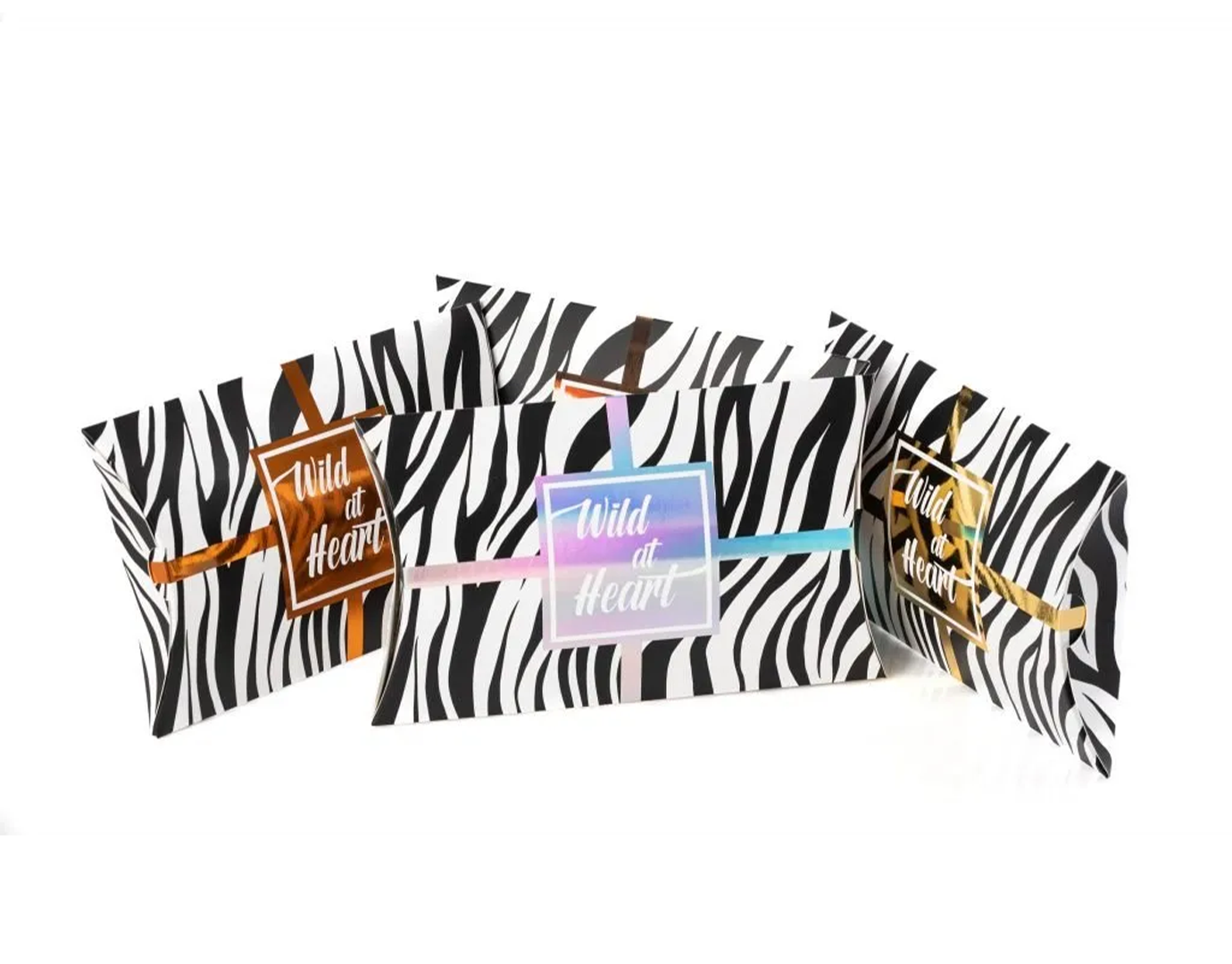 Zebra print bags with 'Wild at Heart' text and colorful ribbons.