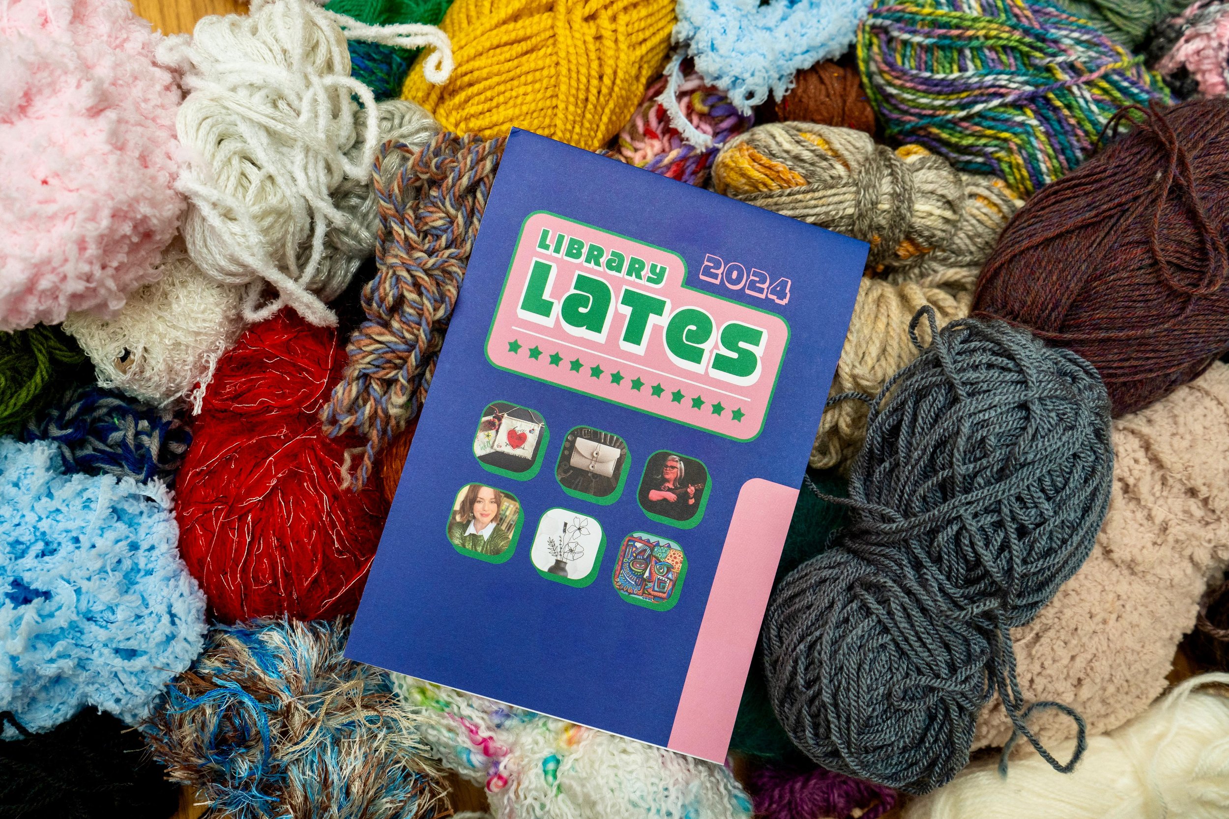 Colorful yarn balls surrounding a booklet titled 'Library Lates 2024' with images on the cover.