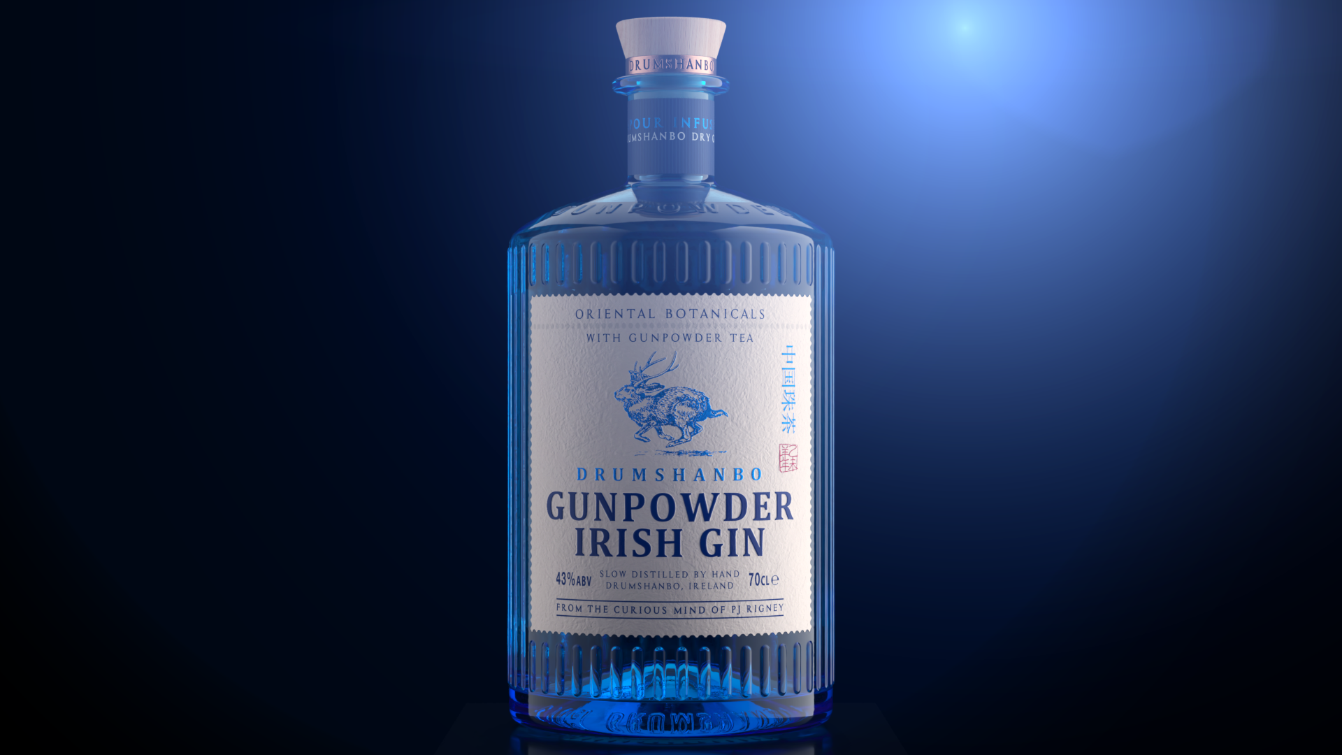 A blue-tinted bottle of Drumshanbo Irish gin with a label featuring a mountain goat illustration, set against a dark background with a blue light shining from the upper right.