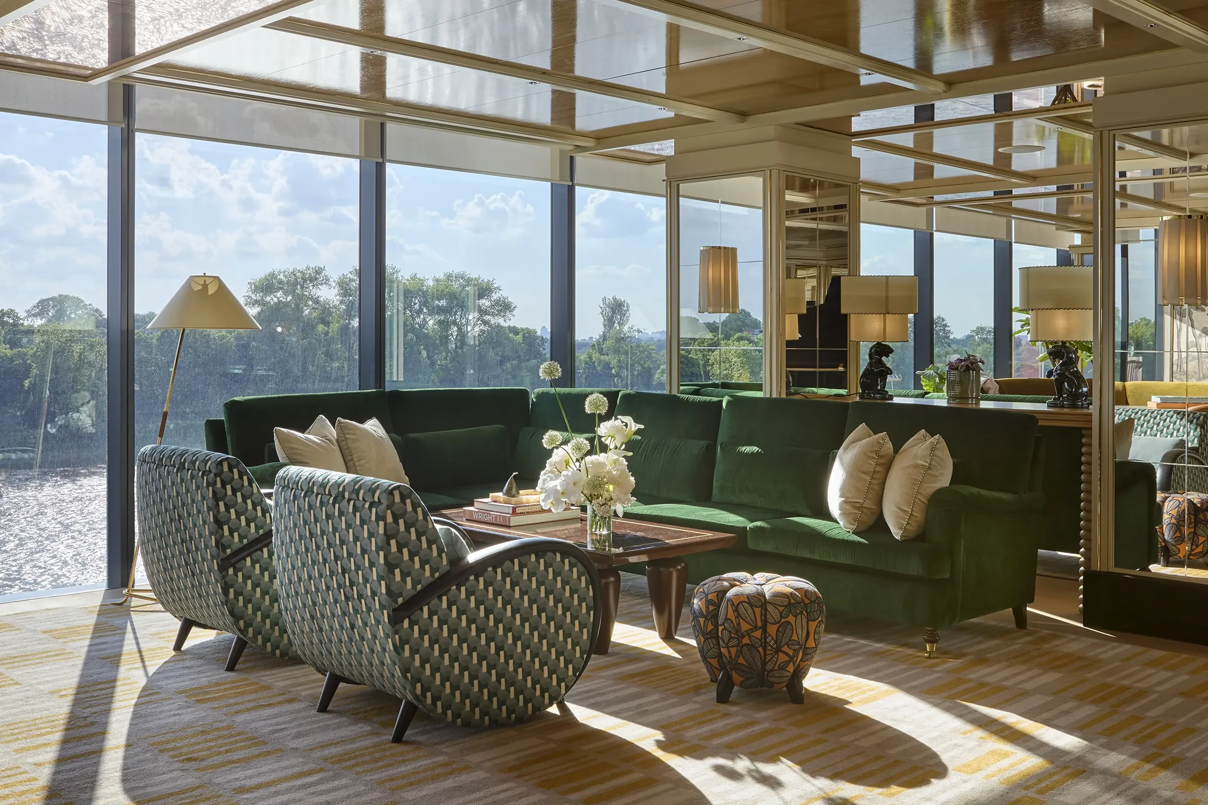 Lighthouse Social lounge interior with green sofa seating and rive views
© Alexander James