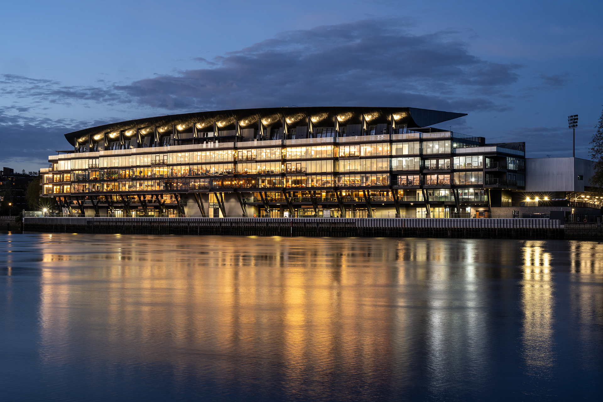 Fulham Pier at Fulham Football Club featuring a unique curved roof design, at dusk.