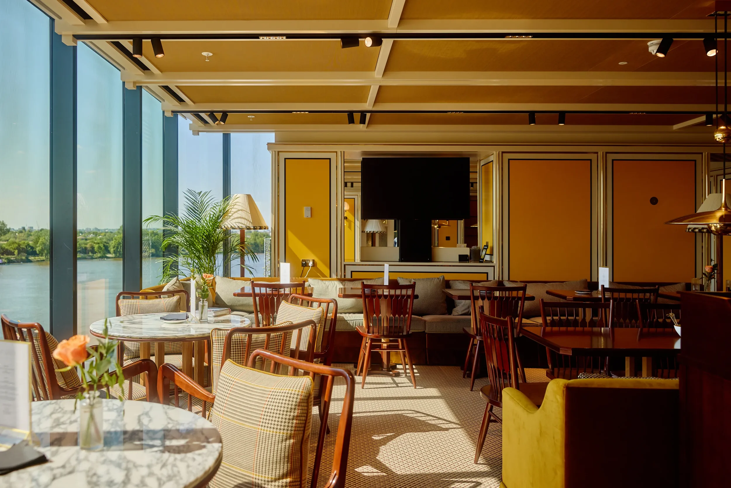Lighthouse Social private members’ club dining area with yellow wall panels.