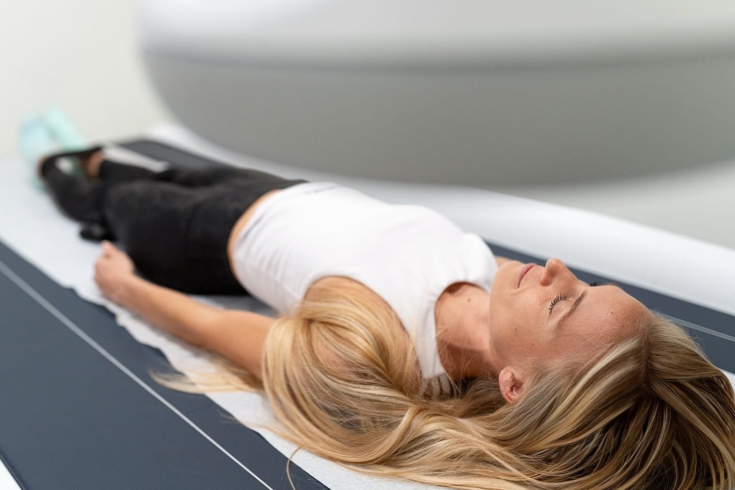 Young woman during DEXA scan at DexaFit