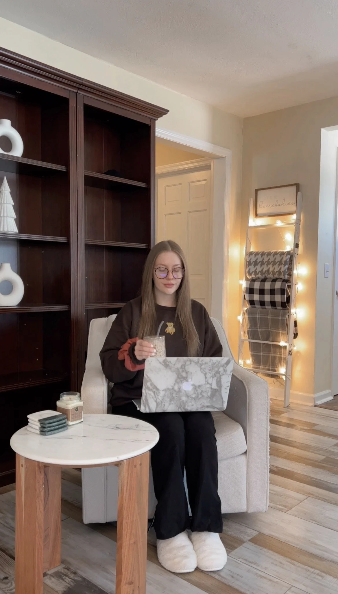 Christa on her laptop with an iced coffee