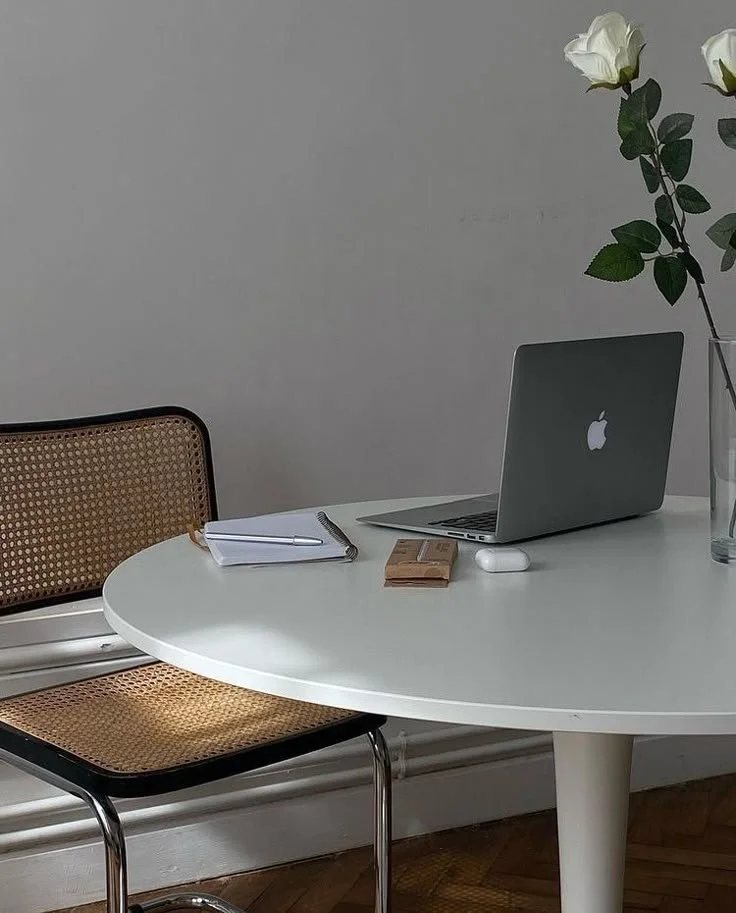 Macbook on a white table.