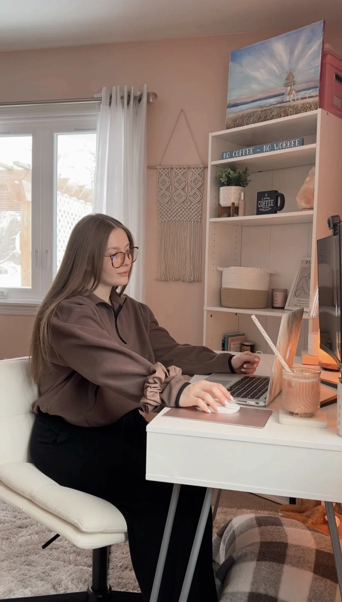 Christa at her desk on her laptop