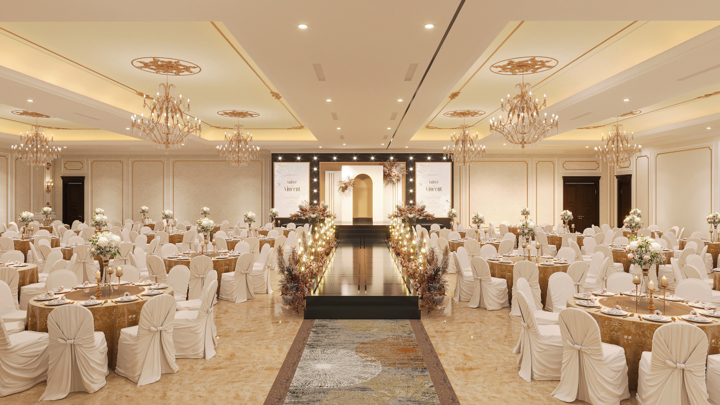 Elegant banquet hall decorated for a wedding reception with round tables, white chairs, floral centerpieces, chandeliers, and a decorated stage at the front.